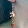 Copper goldstone earrings worn