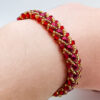 Flat spiral bracelet red and gold clasp worn