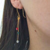 Gold-plated Swarovski drop earrings worn